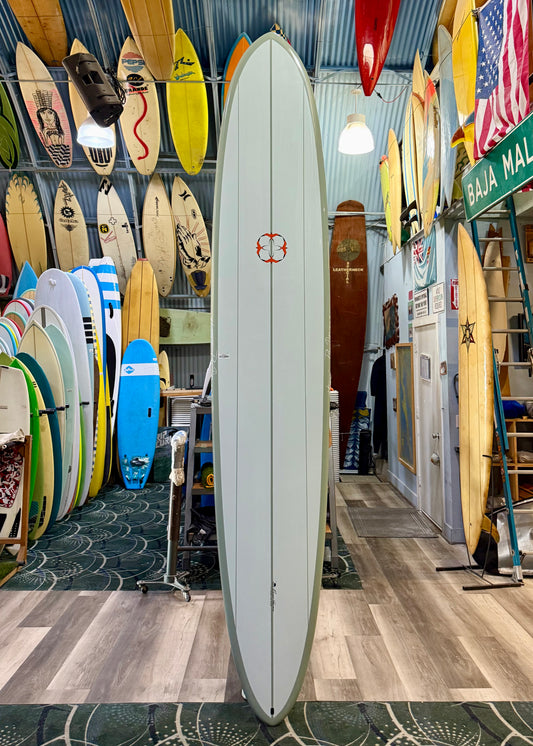Surfboard store with various surfboards displayed on racks and walls.
