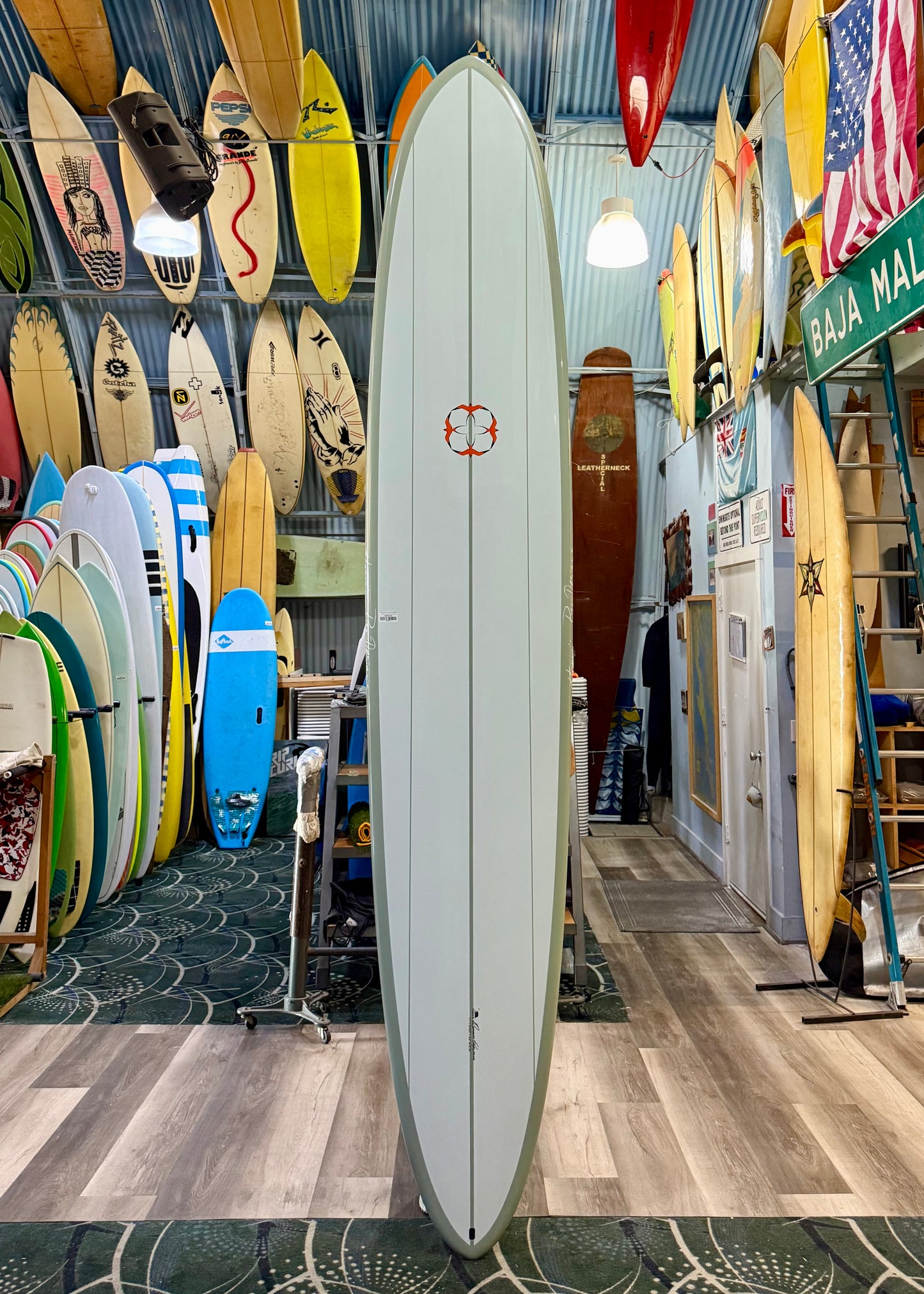 Surfboard store with various surfboards displayed on racks and walls.